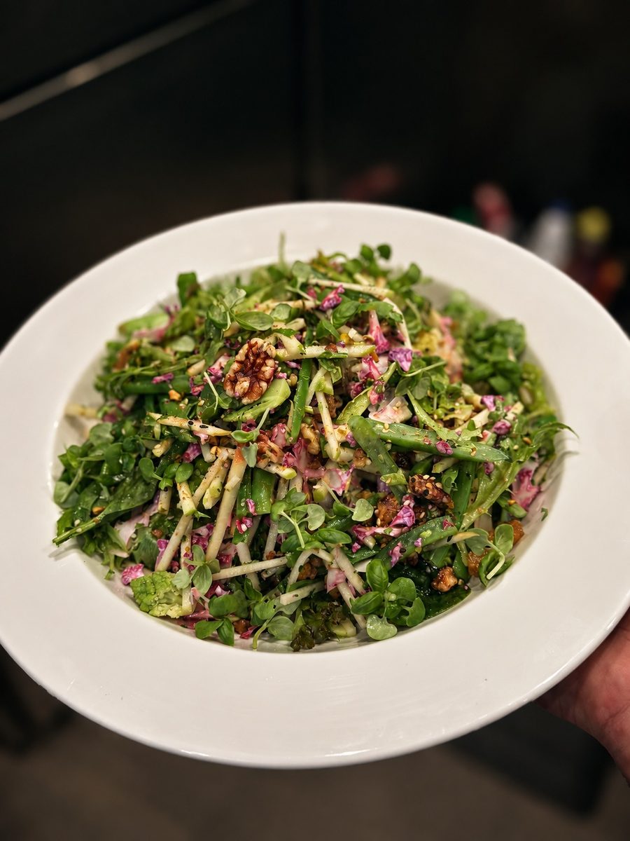 Delicate herb salad with flowers and shaved vegetables